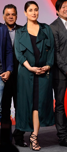 Bebo stuns us in a black dress with olive-green coat
